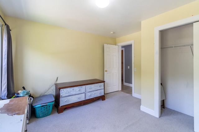 bedroom with light carpet and a closet