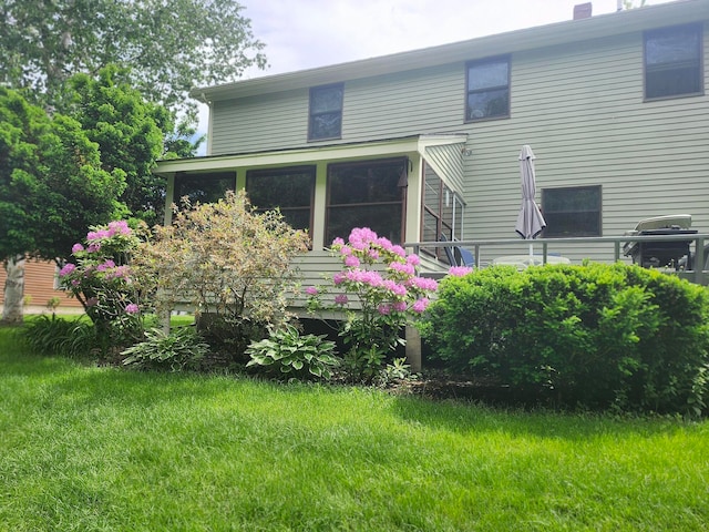 back of house featuring a yard