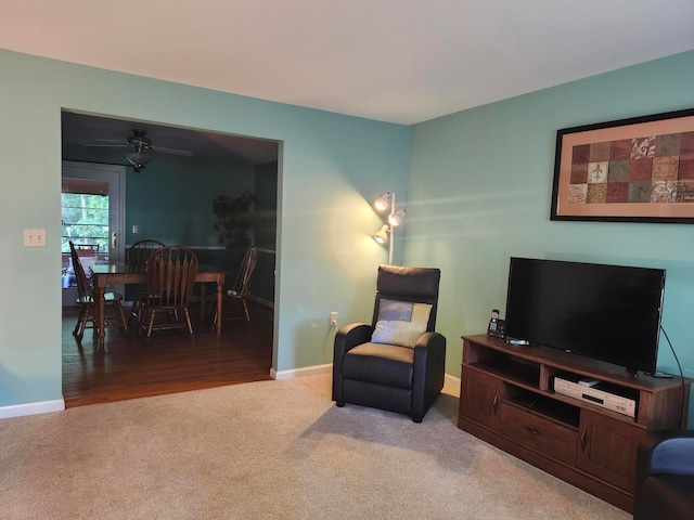 sitting room with wood-type flooring and ceiling fan