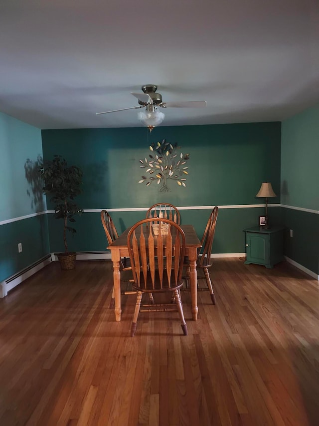 dining room featuring ceiling fan, a baseboard radiator, and hardwood / wood-style floors