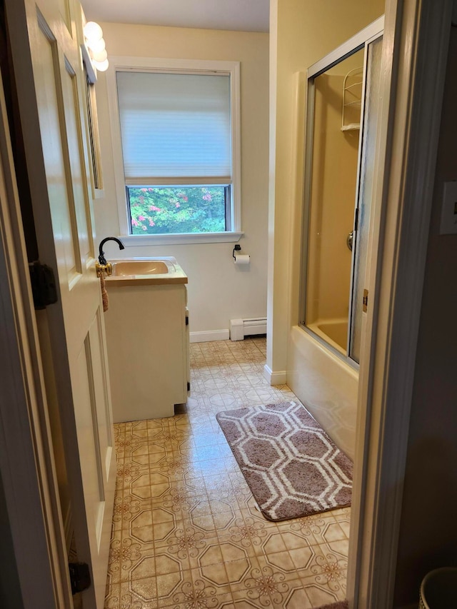 bathroom featuring shower / bath combination with glass door, vanity, a baseboard radiator, and tile patterned floors