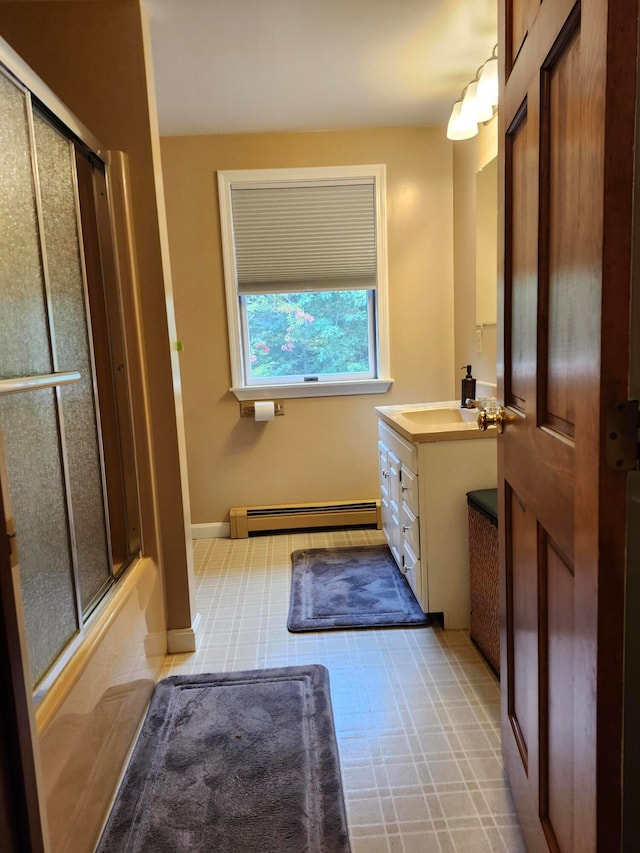 bathroom with shower / bath combination with glass door, vanity, and a baseboard radiator