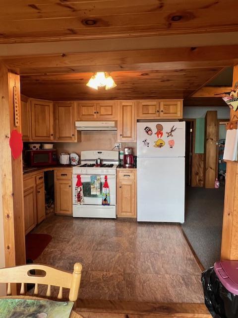 kitchen featuring under cabinet range hood, white appliances, and wood ceiling