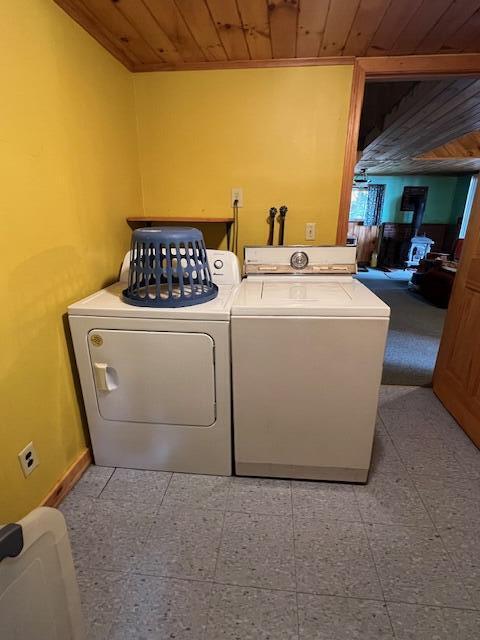 laundry area with washing machine and dryer, laundry area, and wood ceiling