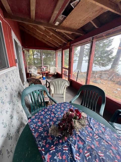 sunroom featuring outdoor dining space