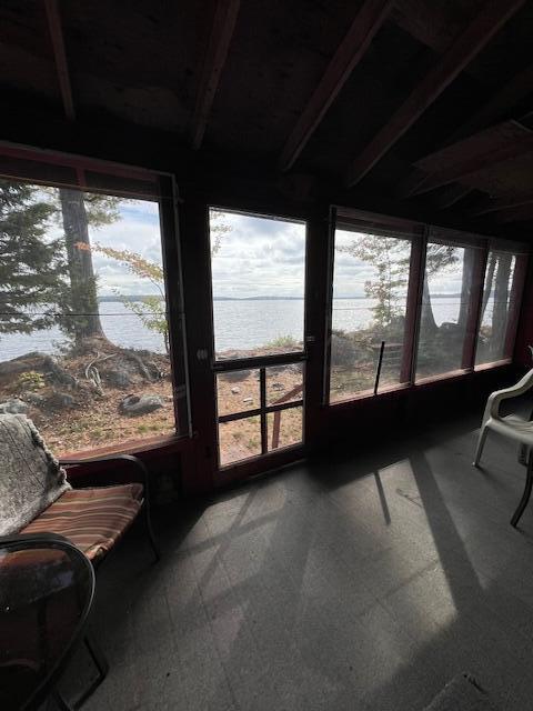 sunroom / solarium with a water view