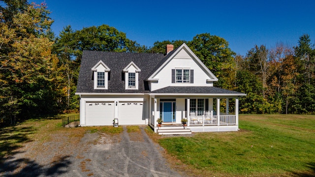 view of front facade featuring covered porch, a front yard, and a garage