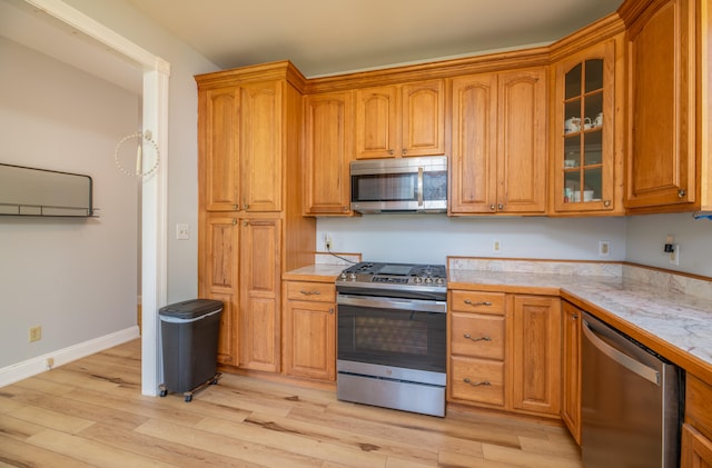 kitchen with stainless steel appliances and light hardwood / wood-style floors