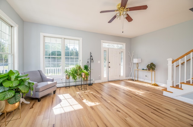 foyer with light hardwood / wood-style floors, baseboard heating, and ceiling fan