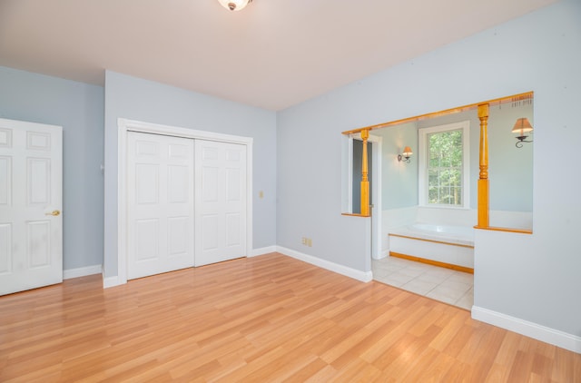 unfurnished bedroom featuring a closet and light hardwood / wood-style floors