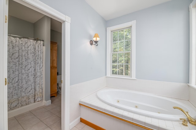 bathroom with tile patterned flooring, toilet, and separate shower and tub