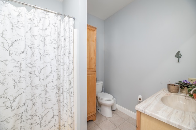 bathroom with tile patterned floors, vanity, and toilet