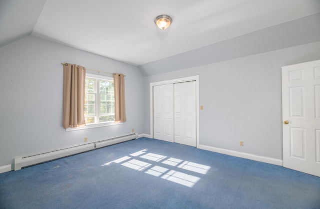 unfurnished bedroom featuring carpet flooring, a closet, vaulted ceiling, and a baseboard heating unit