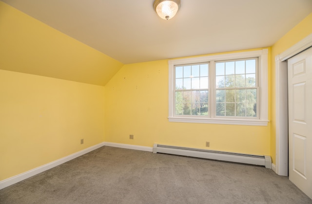 bonus room with a baseboard radiator, vaulted ceiling, and carpet floors