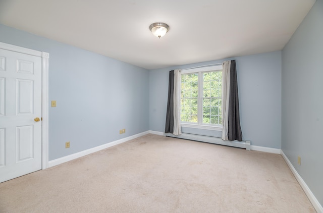 carpeted empty room with a baseboard radiator