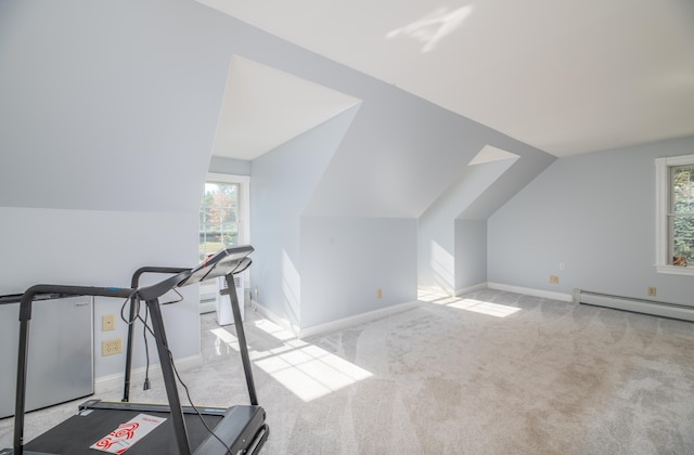 workout room featuring light carpet, lofted ceiling, and baseboard heating