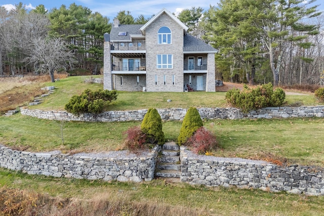 96 Bunker Hill Rd, Newcastle, ME 04553 - rear view of property featuring a balcony, a lawn, a chimney, stone siding, and roof with shingles