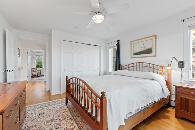 96 Bunker Hill Rd, Newcastle, ME 04553 - bedroom featuring light wood finished floors, a closet, multiple windows, and ceiling fan