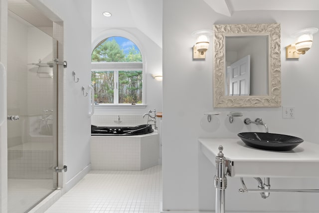 bathroom with tile patterned flooring, sink, independent shower and bath, and vaulted ceiling