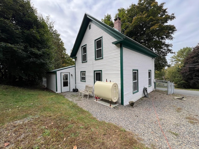 rear view of house featuring a yard