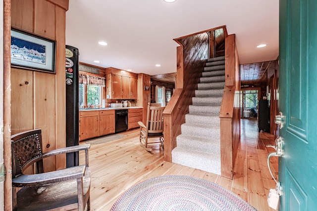 kitchen featuring dishwasher, light hardwood / wood-style floors, and plenty of natural light