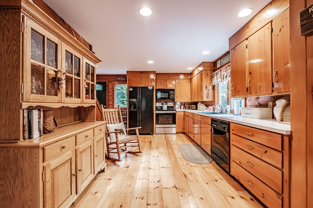 11 Goss Pond Rd, Bethel, ME 04217 - kitchen with black appliances, light wood-type flooring, light countertops, recessed lighting, and glass insert cabinets