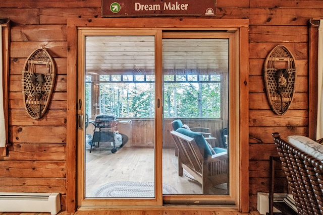 doorway with a baseboard radiator and plenty of natural light