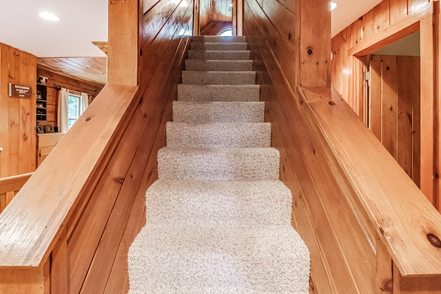 staircase with wooden walls