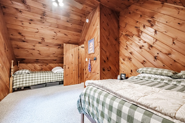 carpeted bedroom featuring lofted ceiling, wood walls, and wooden ceiling