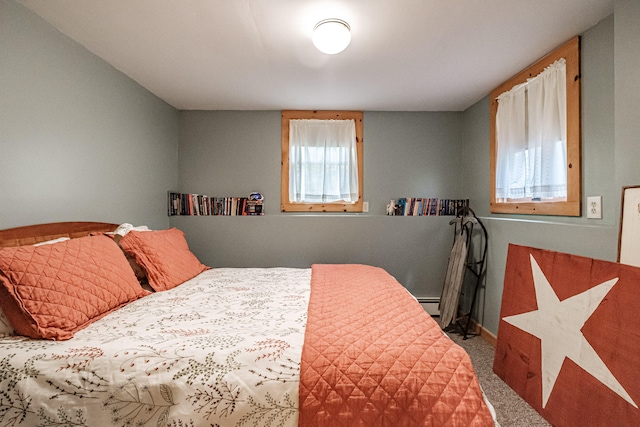 carpeted bedroom featuring a baseboard radiator