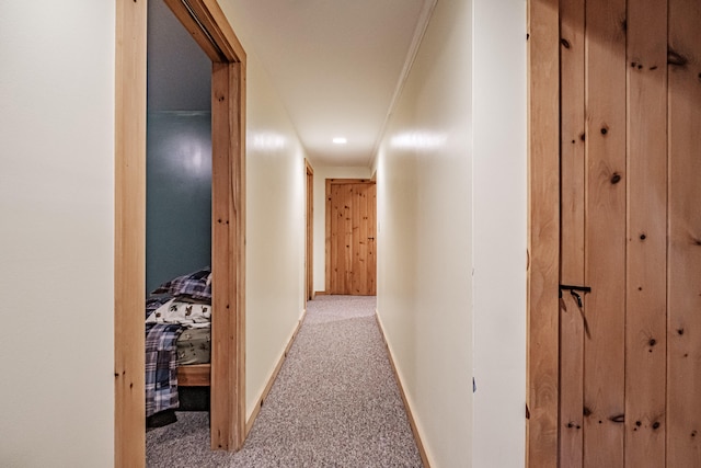 hallway featuring light carpet and ornamental molding