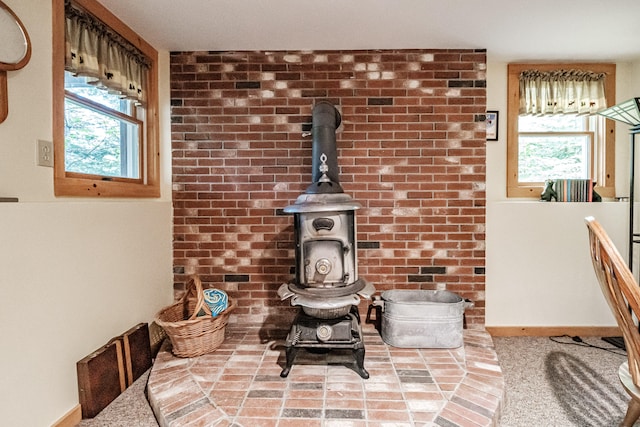 details with a wood stove and carpet flooring