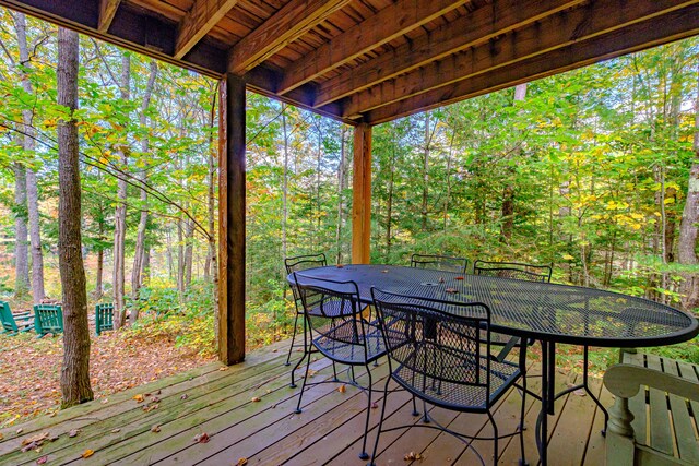 11 Goss Pond Rd, Bethel, ME 04217 - wooden terrace with outdoor dining area and a wooded view