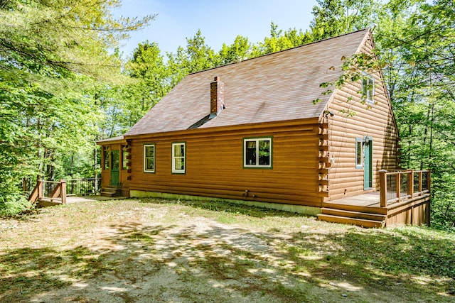 11 Goss Pond Rd, Bethel, ME 04217 - back of property featuring log siding and a deck