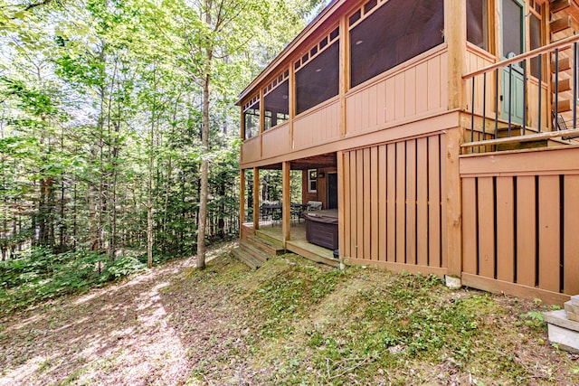 11 Goss Pond Rd, Bethel, ME 04217 - view of side of property featuring a sunroom, a wooden deck, and a hot tub