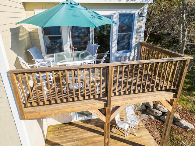 wooden terrace featuring outdoor dining area