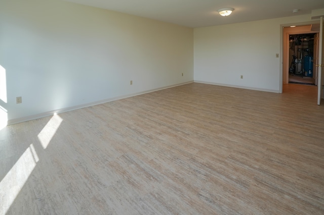 empty room featuring light wood-style flooring and baseboards