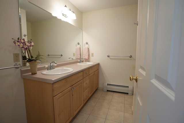 bathroom featuring a baseboard heating unit, double vanity, tile patterned flooring, and a sink