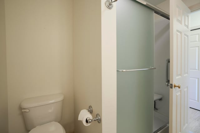 bathroom with toilet and a shower stall