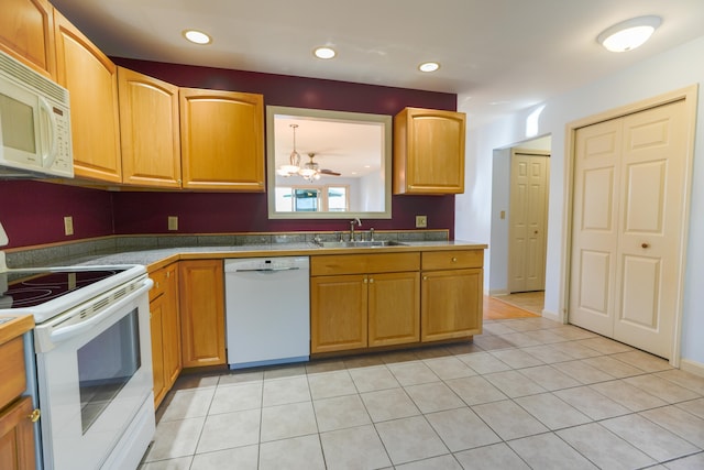 kitchen featuring white appliances, light tile patterned floors, a sink, and recessed lighting