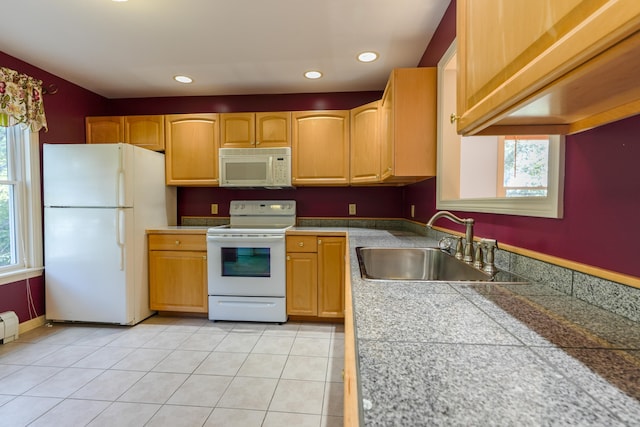 kitchen featuring light tile patterned floors, white appliances, a sink, and recessed lighting