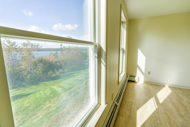 entryway with baseboards, baseboard heating, and light wood-style floors