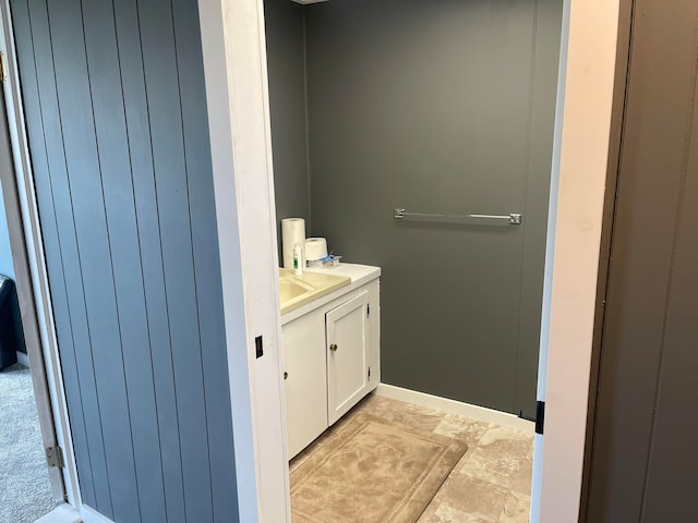 bathroom with wood walls and vanity