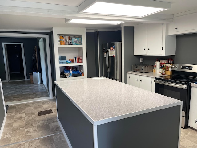 kitchen with white cabinetry, a center island, and stainless steel appliances