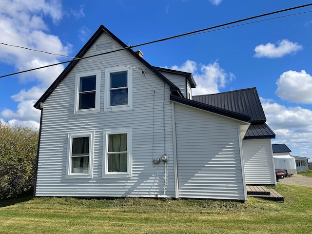 view of side of property with a yard