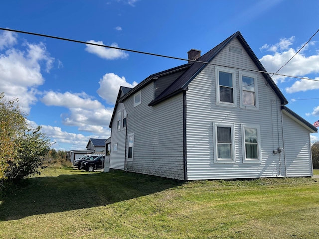 view of side of home with a lawn