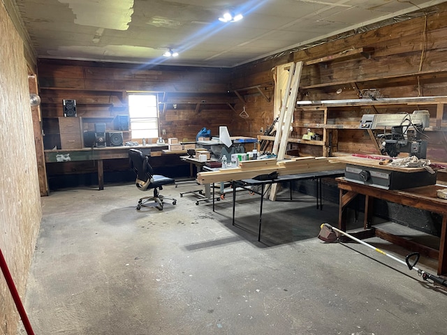 interior space with wood walls and a workshop area