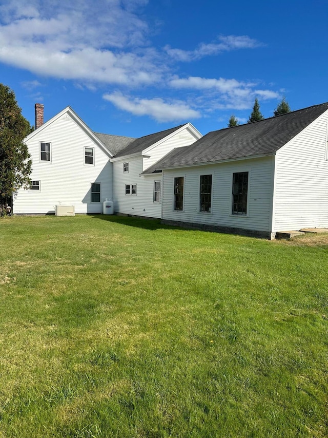 rear view of house with a lawn