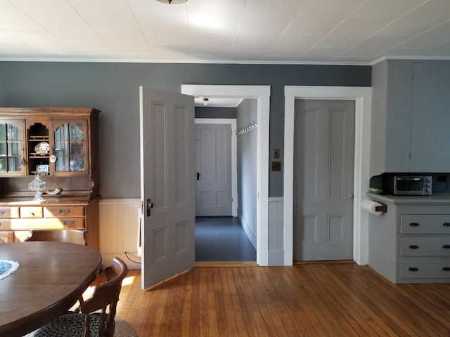 dining room featuring crown molding and hardwood / wood-style floors