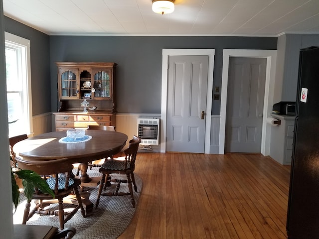 dining space featuring heating unit and wood-type flooring